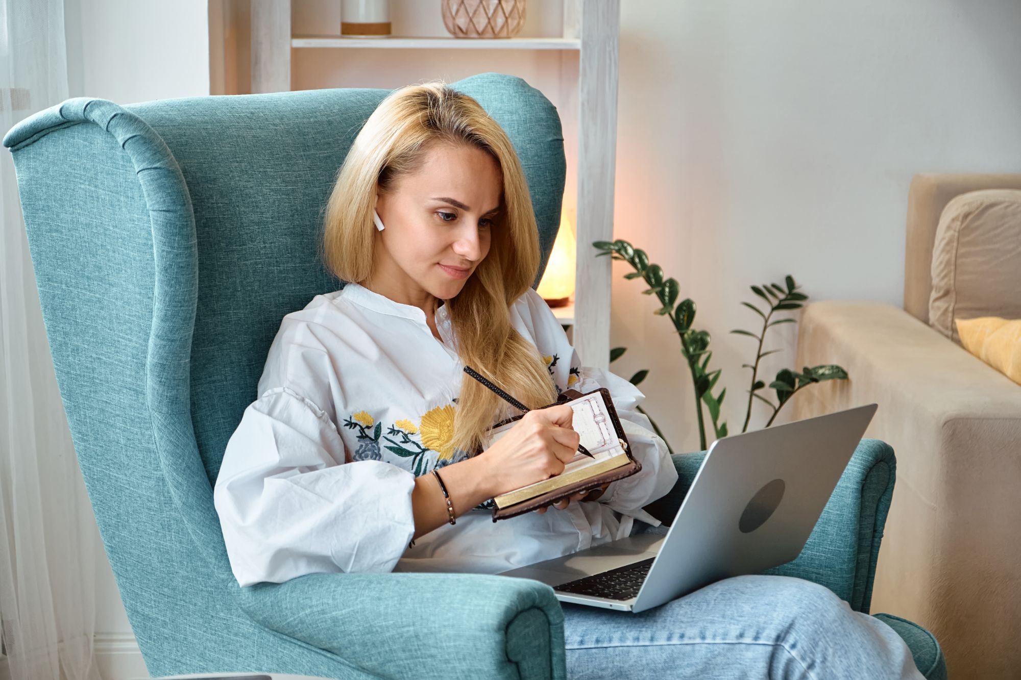 Woman taking notes during a virtual coaching session