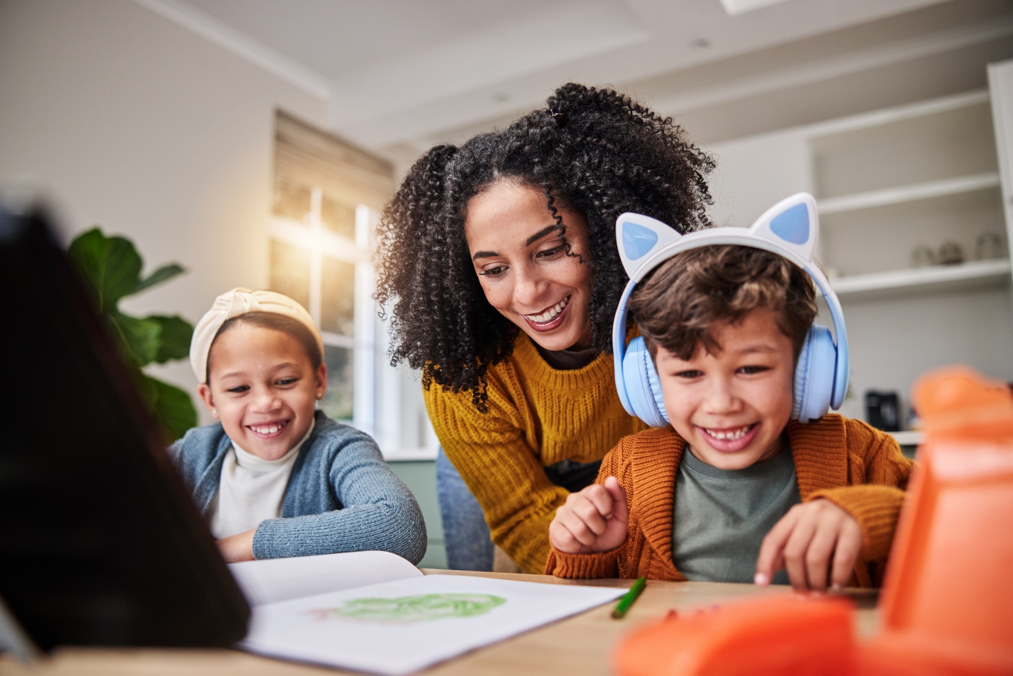 A mother and her two children smiling together at home